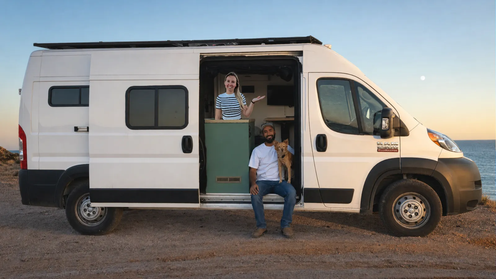Dave and a companion with their dog at the open side door of their camper van